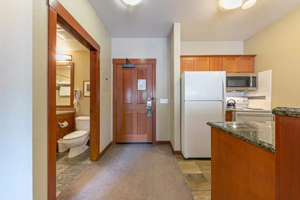 a kitchen with a refrigerator and a sink