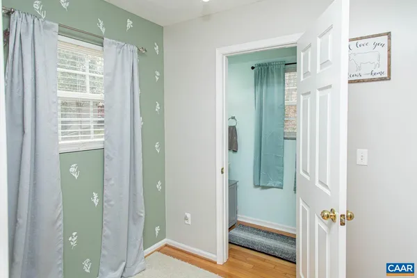 a bathroom with a plant and a window
