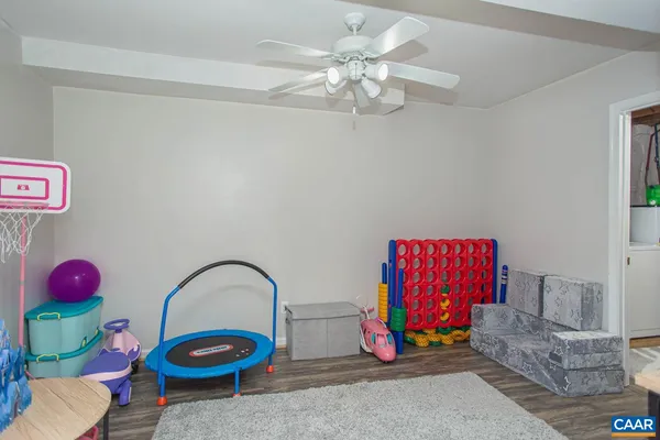 a bedroom with furniture and a flat screen tv