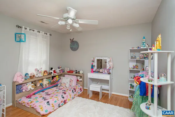 a bedroom with furniture and a baby crib
