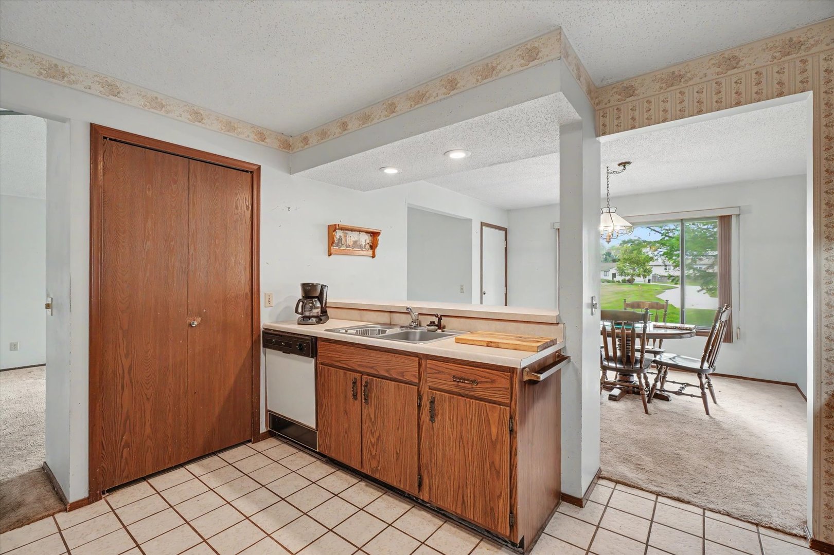 711 Higgins Road Champaign, IL 61822 - Photo 9 of 23 a kitchen with a sink and chairs