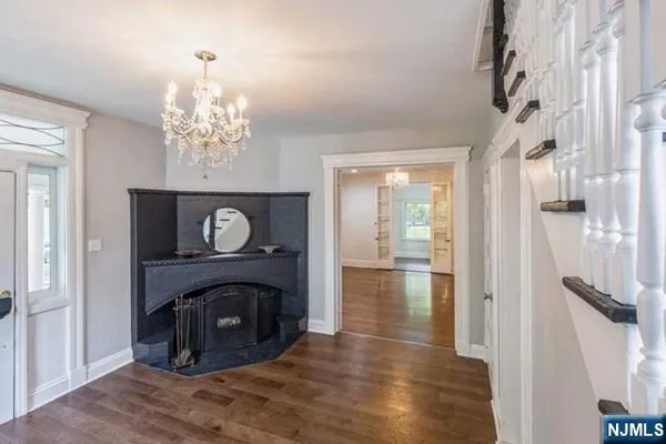 a view of a room with wooden floor and windows