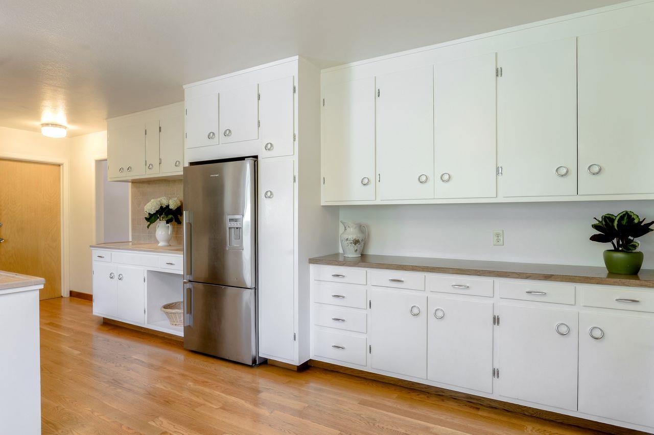 77 View Street Los Altos, CA 94022 - Photo 8 of 30 a kitchen with stainless steel appliances white cabinets and wooden floors