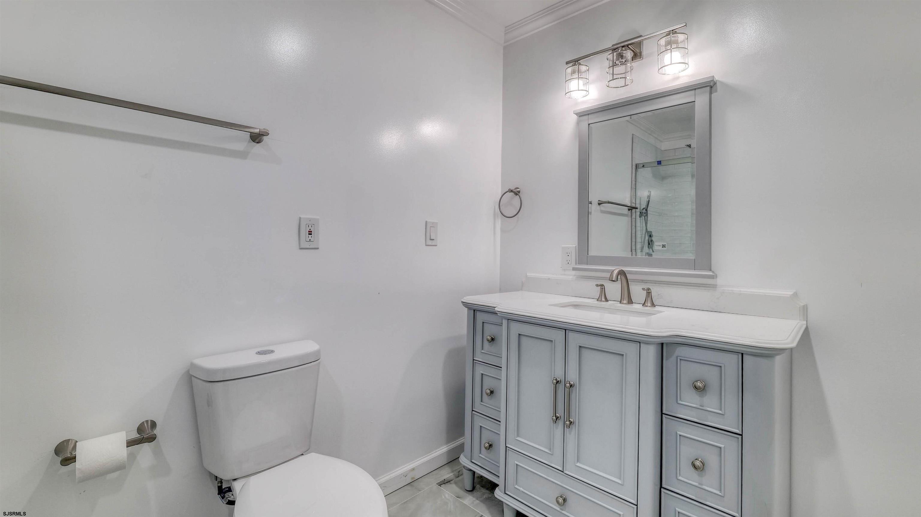 19 Merion Drive Somers Point, NJ 08244 - Photo 13 of 30 a bathroom with a toilet a sink and mirror