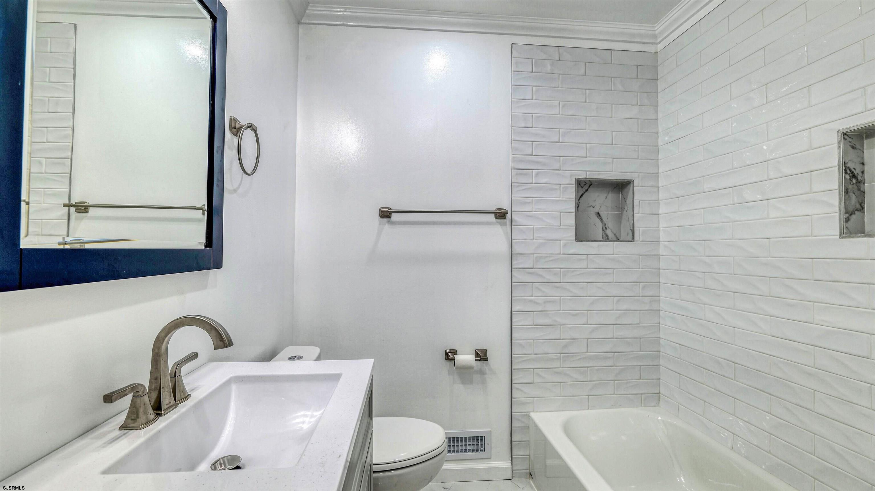 19 Merion Drive Somers Point, NJ 08244 - Photo 17 of 30 a bathroom with a sink a toilet and bathtub