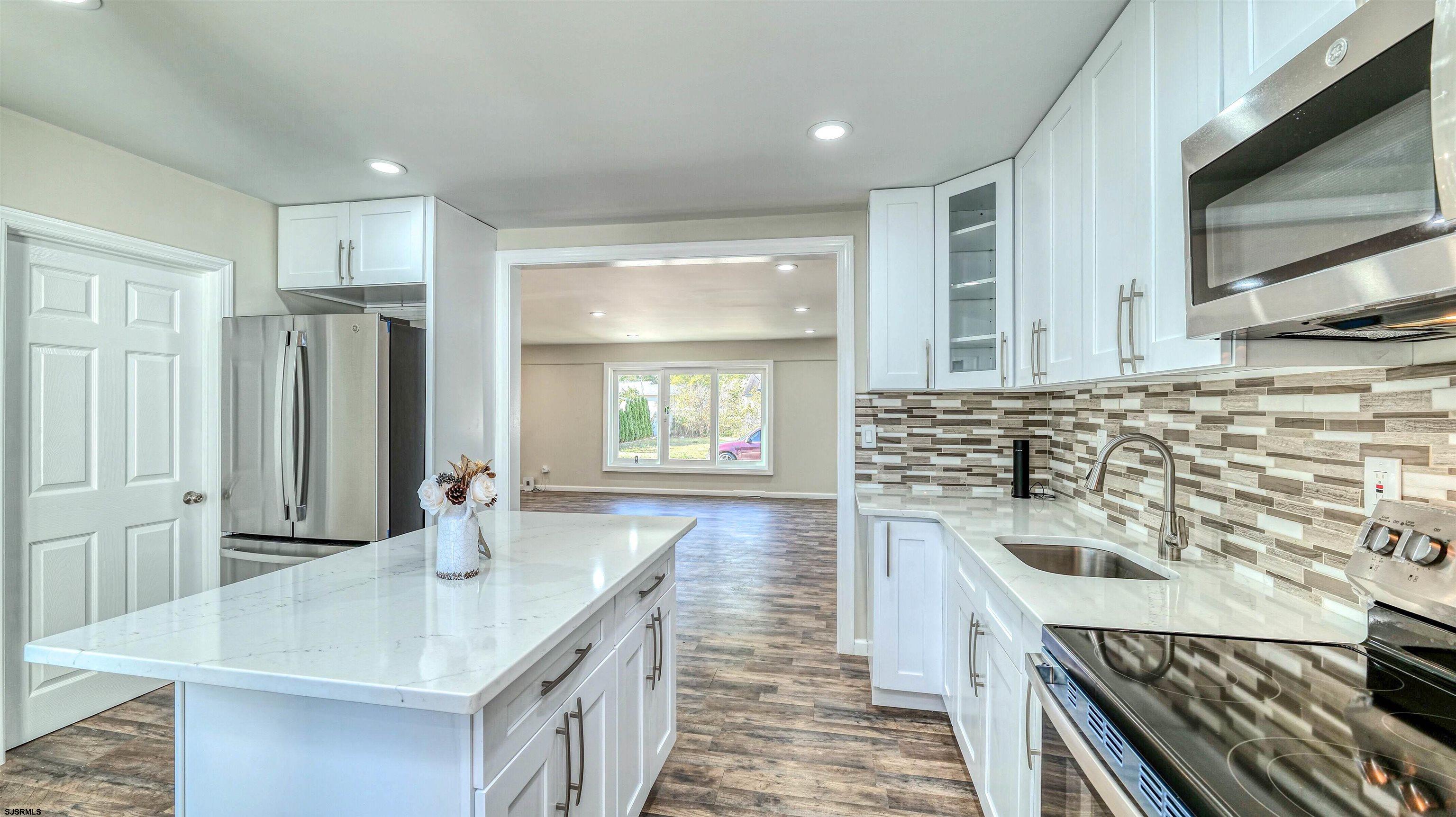19 Merion Drive Somers Point, NJ 08244 - Photo 6 of 30 a kitchen with a sink stove and refrigerator