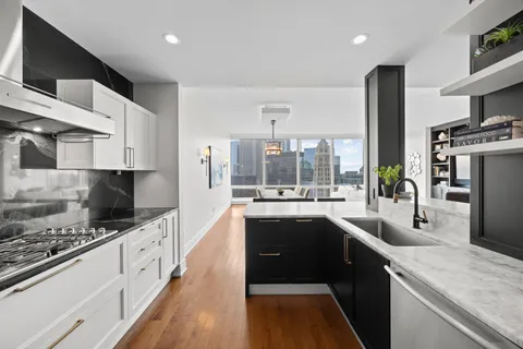 a kitchen with stainless steel appliances a sink stove and refrigerator