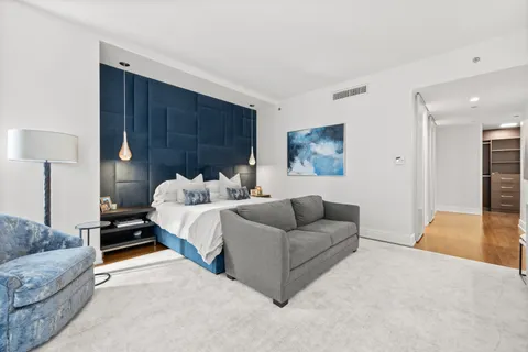 a bedroom with bed and a couch