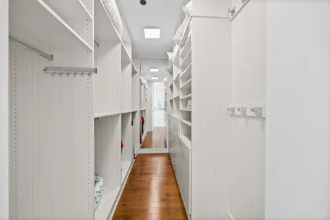 a view of walk in closet with empty racks