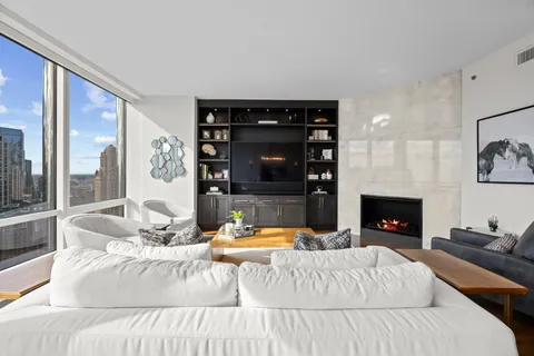 a living room with furniture a fireplace and a flat screen tv