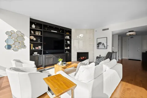 a living room with fireplace furniture and a flat screen tv