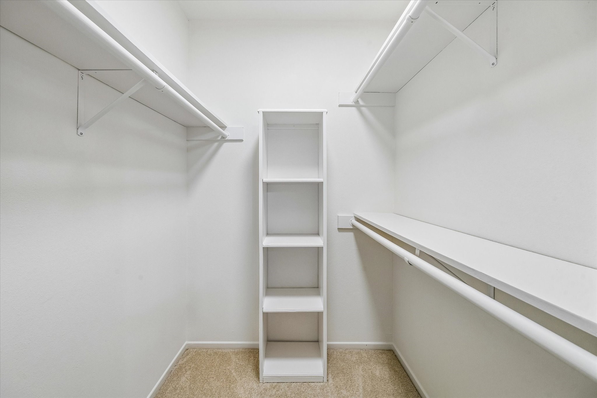 357 North Post Oak Lane, Unit 102 Houston, TX 77024 - Photo 16 of 18 The walk-in closet for the secondary bedroom also features shelves and hanging rods. In the hallway, there is another large closet for overflow storage.
