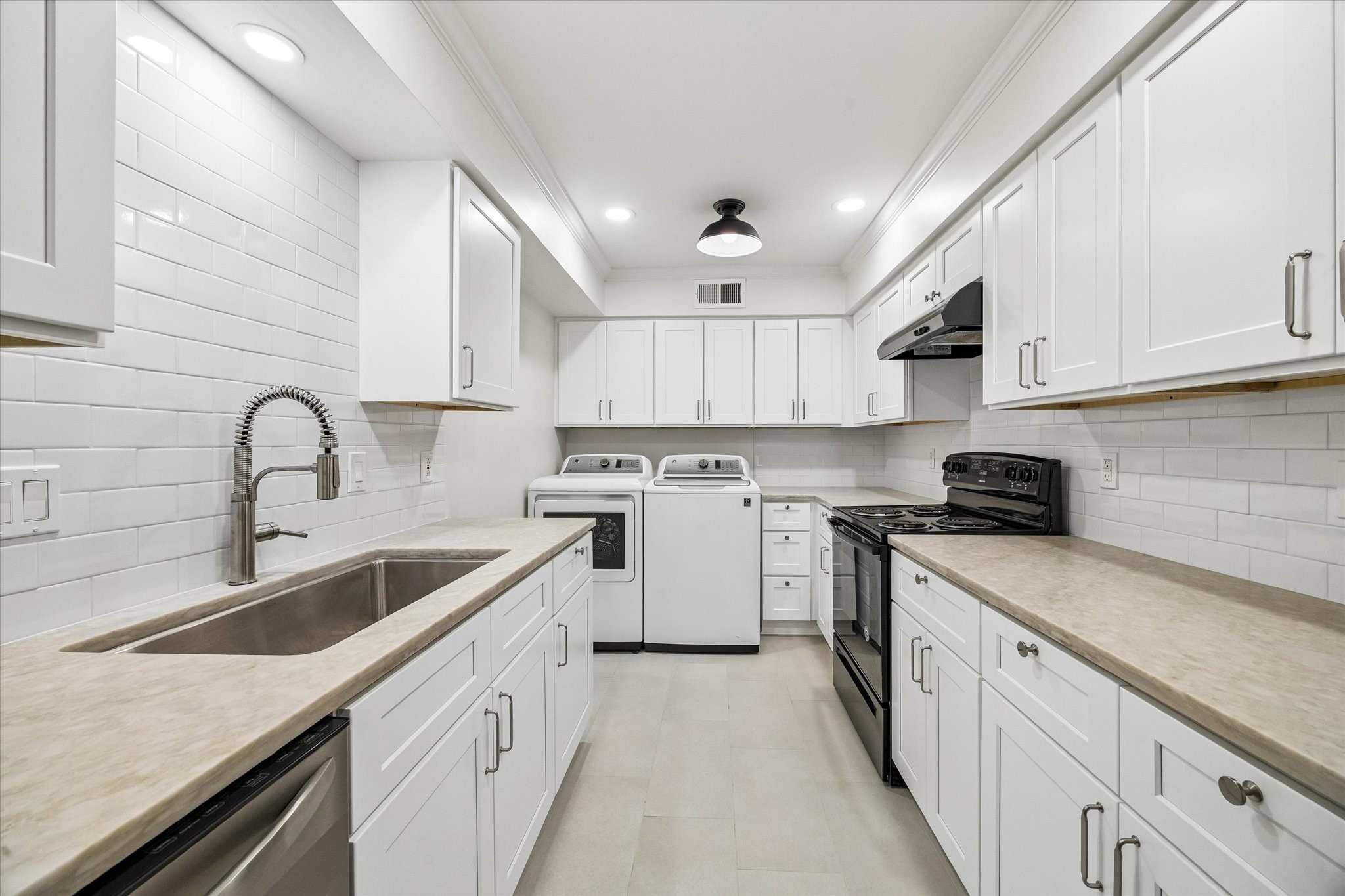 357 North Post Oak Lane, Unit 102 Houston, TX 77024 - Photo 6 of 18 The kitchen has been renovated with stone counters, new soft close cabinets, and lighting. A full size washer and dryer provide convenience.