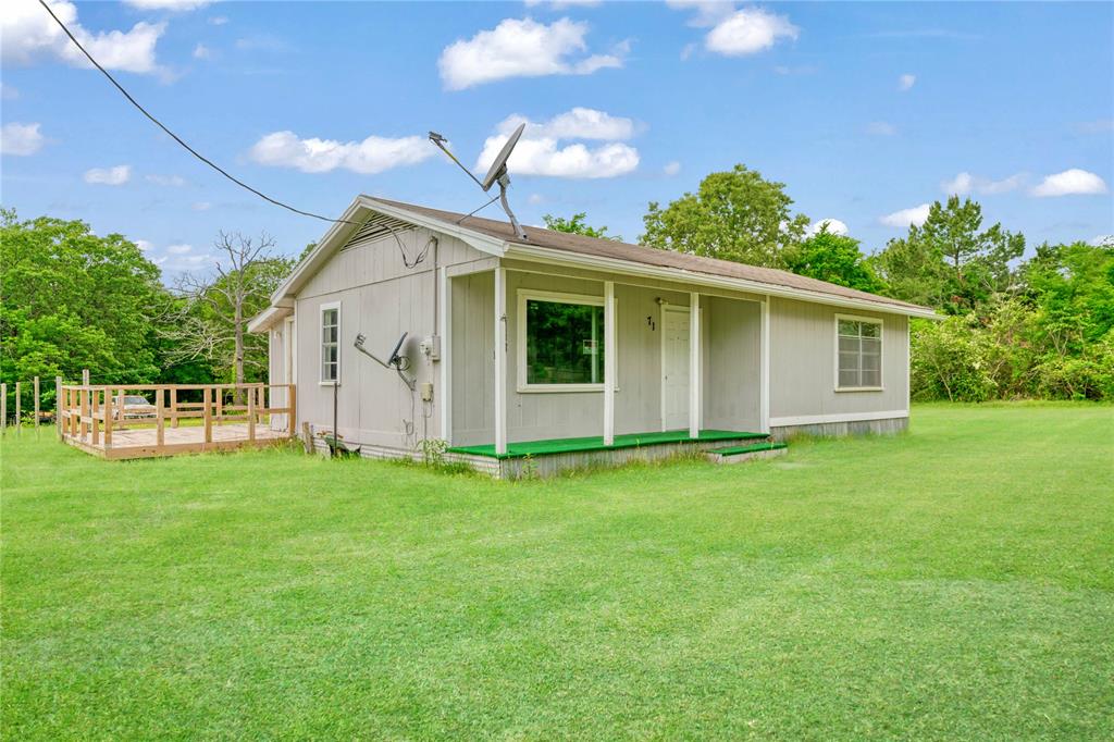 71 Pr 45035 Powderly Tx 75473 Powderly, TX 75473 - Photo 2 of 10 a view of a backyard with plants and large trees