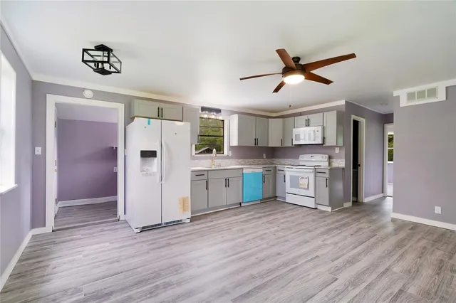 a kitchen with stainless steel appliances a refrigerator and a stove top oven