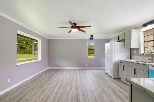a view of workspace with wooden floor and a window