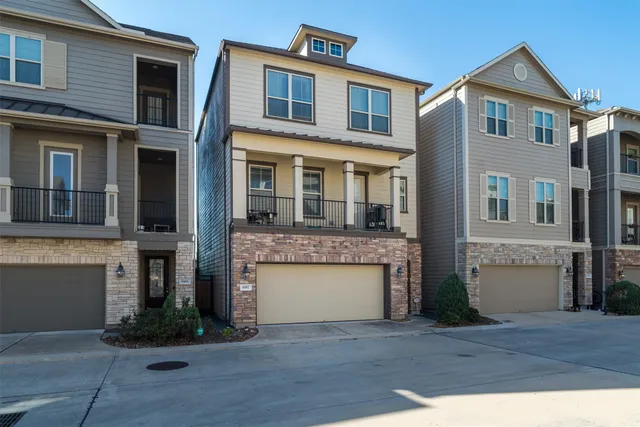 a front view of a house with yard and parking