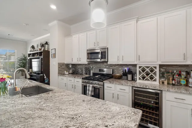 a kitchen with granite countertop a stove sink and cabinets