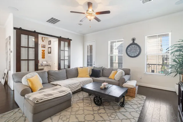 a living room with furniture a table and a large window