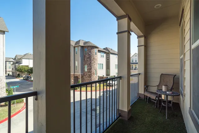 a view of a balcony with chair and table