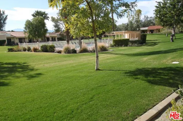 a view of a building with a tree in front