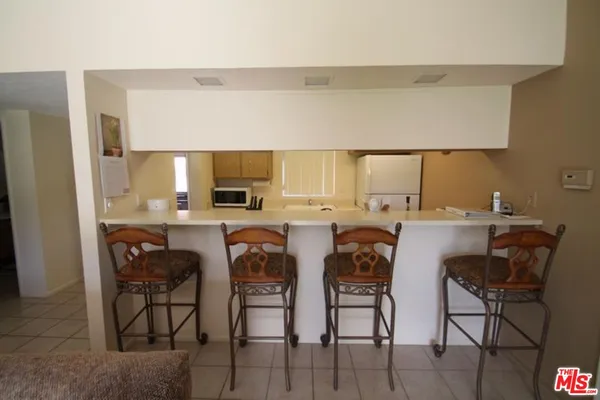 a view of kitchen with cabinets table and chairs