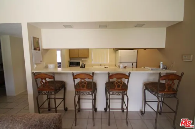 a view of kitchen with cabinets table and chairs