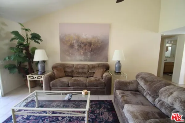 a living room with furniture and a potted plant