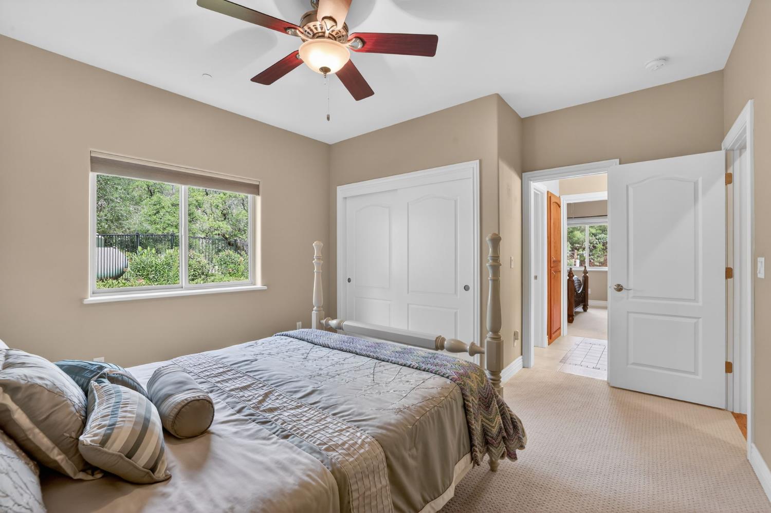 4554 Cross Creek Road Cool, CA 95614 - Photo 45 of 92 a bedroom with a bed and a chandelier