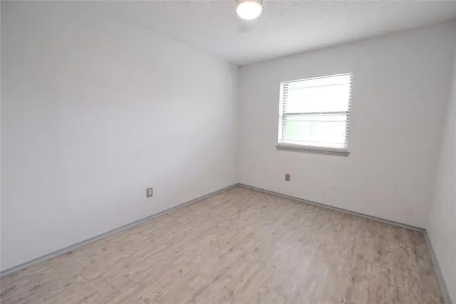 a view of an empty room with closet area