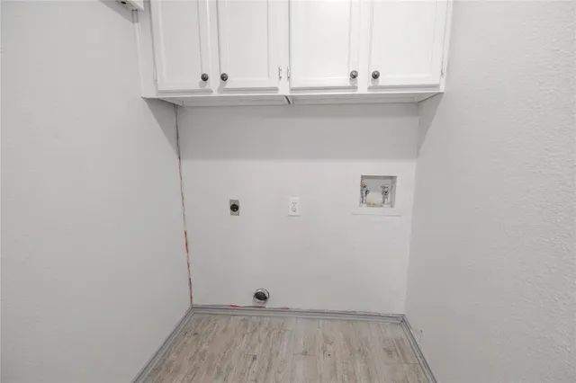 a kitchen with white cabinets stainless steel appliances and sink