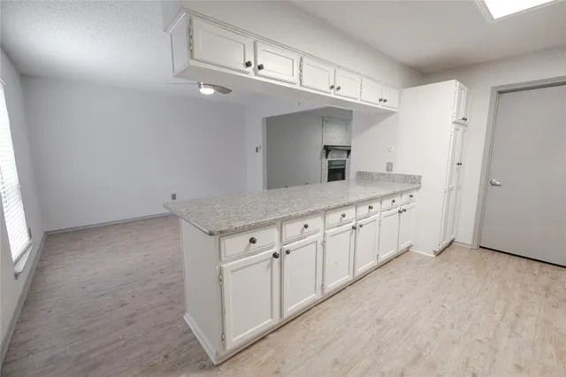 a kitchen with stainless steel appliances granite countertop a refrigerator a stove and a sink