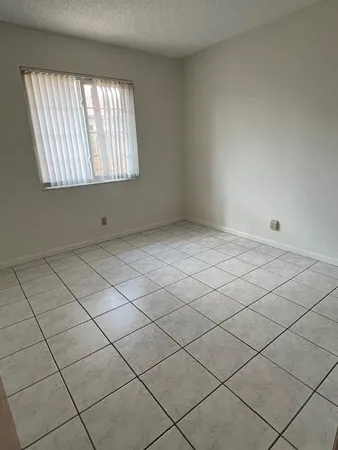 a view of an empty room and a window