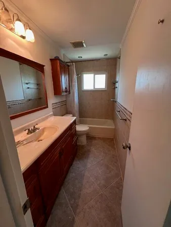 a bathroom with a double vanity sink mirror and toilet