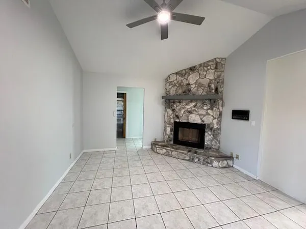 a view of an empty room with a fireplace
