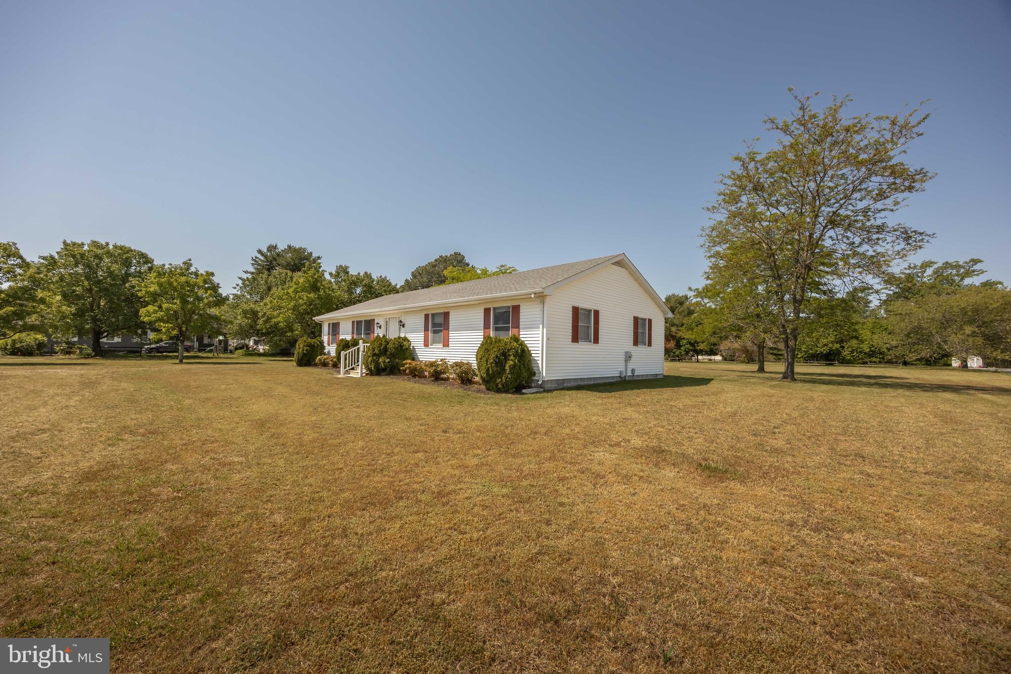 9830 Sharptown Road Mardela Springs, MD 21837 - Photo 51 of 51 a white house sitting in middle of forest
