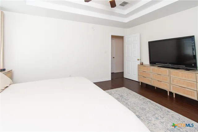 a bedroom with a bed and flat screen tv