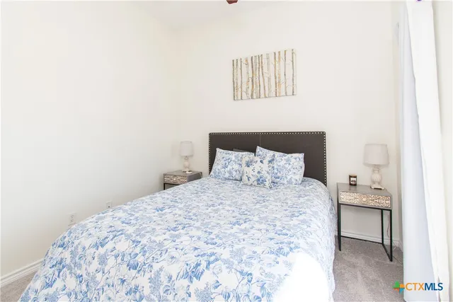 a large bed sitting in a bedroom next to a wall