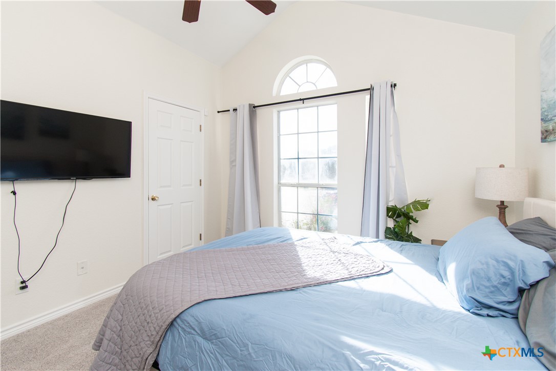 103 Corral Court Harker Heights, TX 76548 - Photo 22 of 27 a bedroom with a bed a flat screen tv and a window