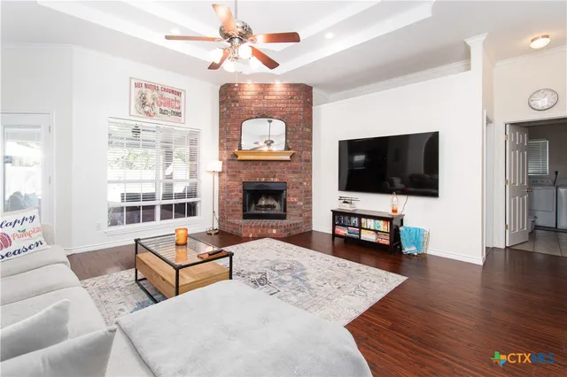 a living room with furniture fireplace and flat screen tv