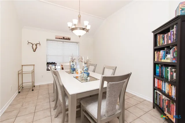 a view of a dining room with furniture and a book shelf
