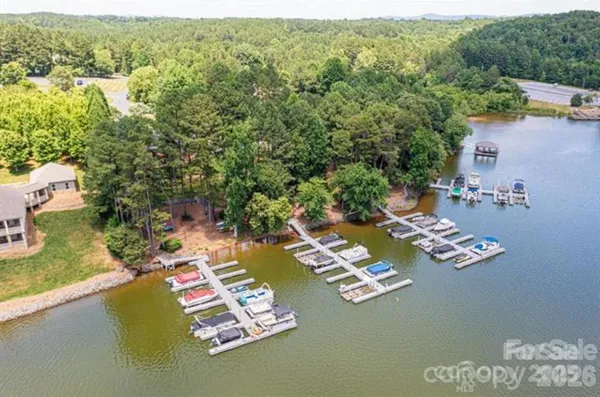 an aerial view of a house with swimming pool and lake view