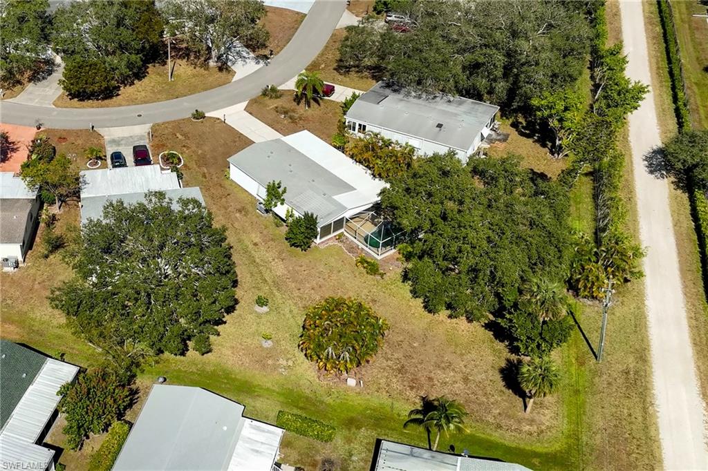 296 Riverwood Road Naples, FL 34114 - Photo 16 of 18 an aerial view of a house with a yard and trees