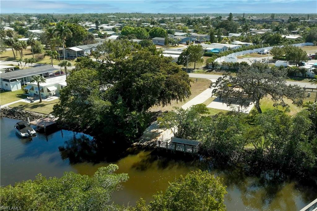 296 Riverwood Road Naples, FL 34114 - Photo 18 of 18 a view of a lake with houses