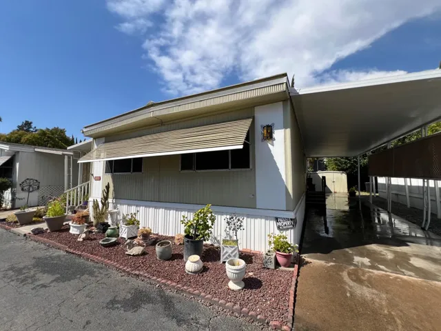 a view of a patio with table and chairs under an umbrella