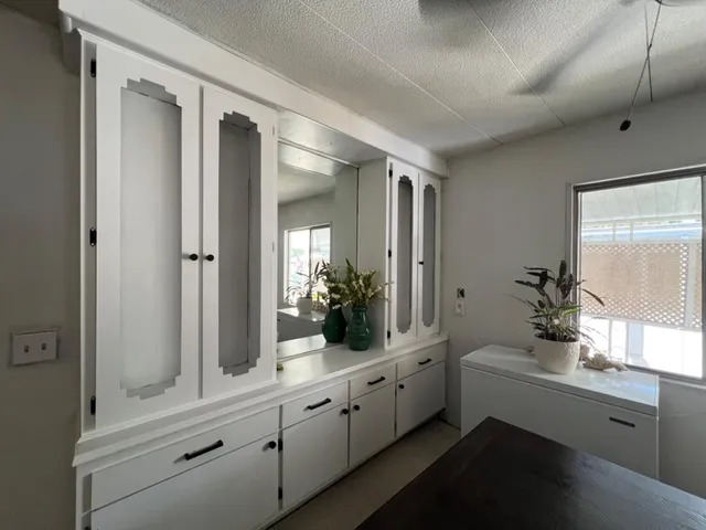 a bathroom with double vanity sink a two mirror a window and a bathtub