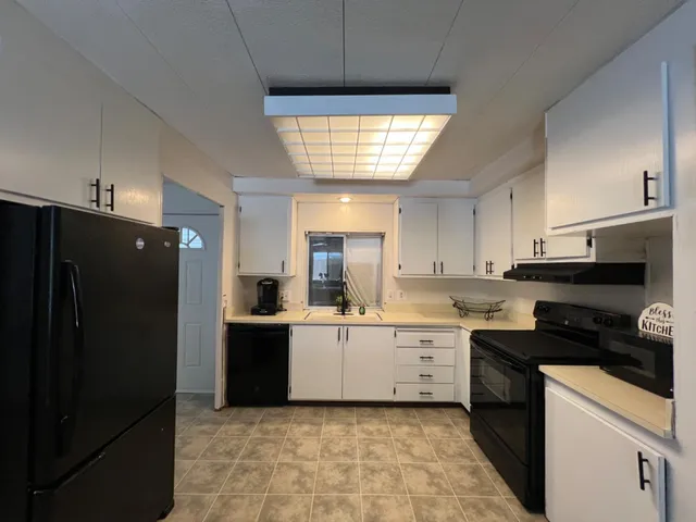 a kitchen with a refrigerator and a sink