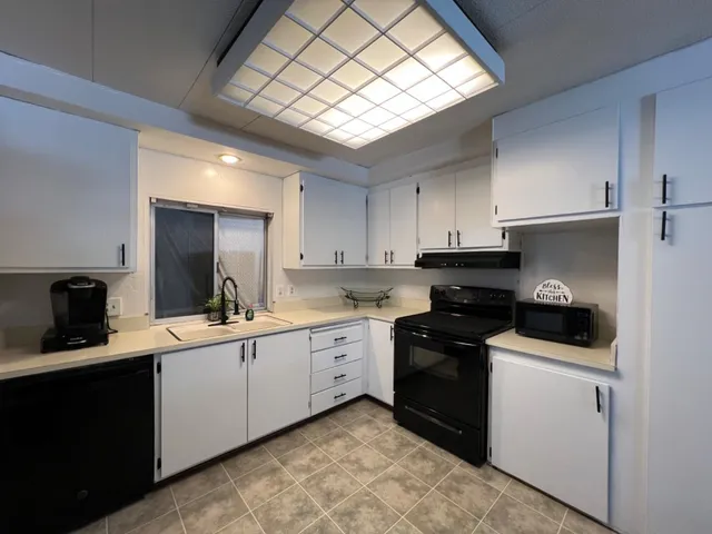 a kitchen with a sink stove and cabinets