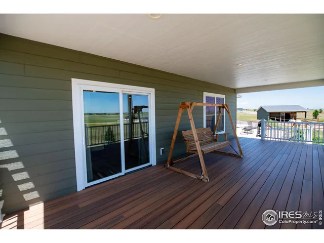 a view of a backyard with floor to ceiling window and wooden fence
