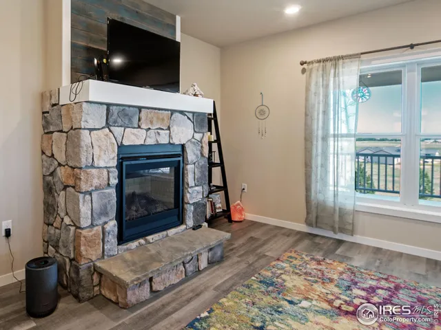 a view of a hallway with wooden floor and stairs
